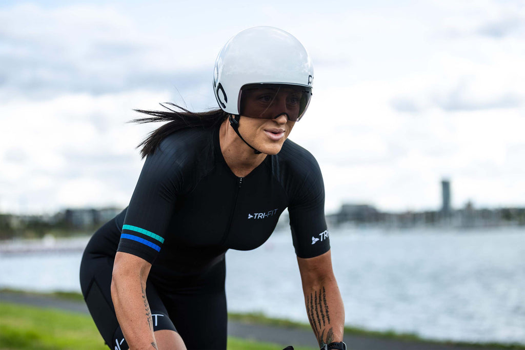 Female riding a bike wearing the EVO black womens tri suit