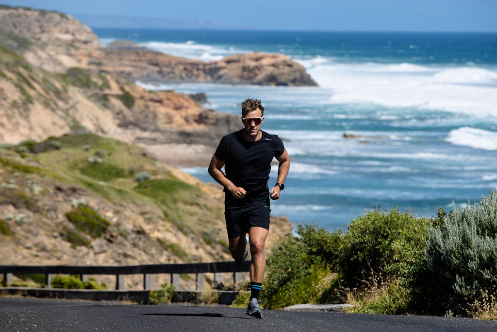 Man running up hill in athletic clothing