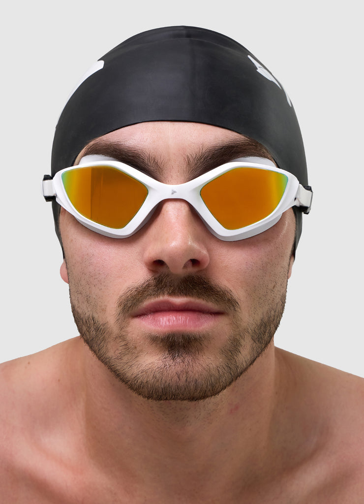 Male swimmer wearing TRI-FIT RAPID-X swim goggles in white