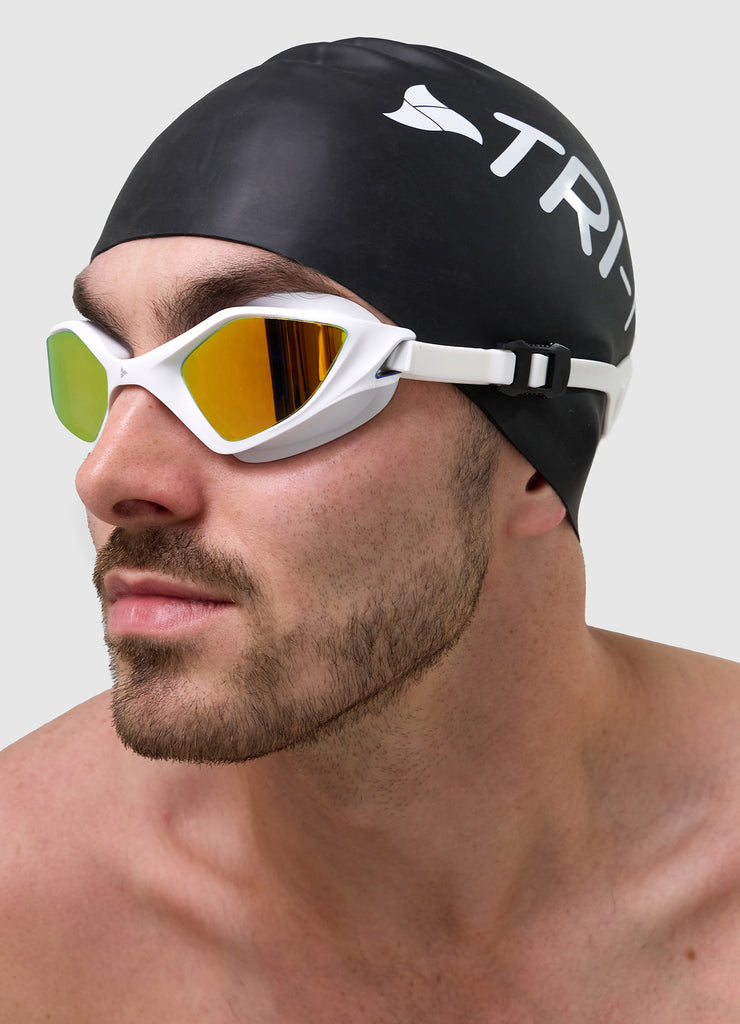 Male swimmer wearing TRI-FIT RAPID-X swim goggles in white