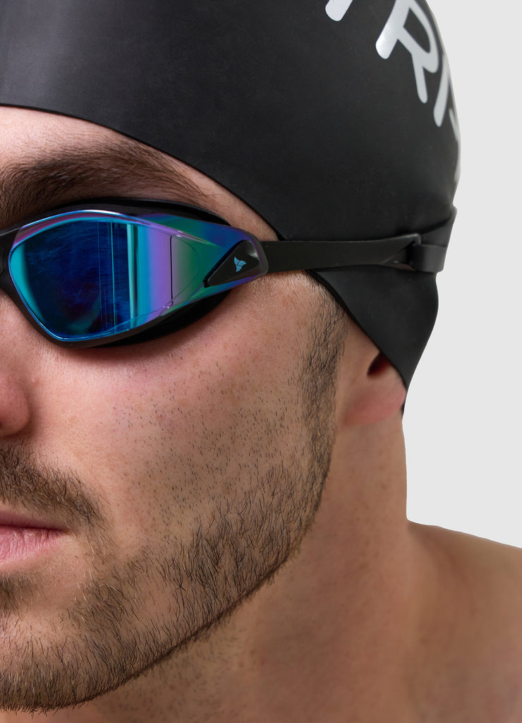 Man wearing TRI-FIT PROPEL Swim Goggles in black with blue/purple mirrored lens. Part of the award-winning TRI-FIT Goggle range.