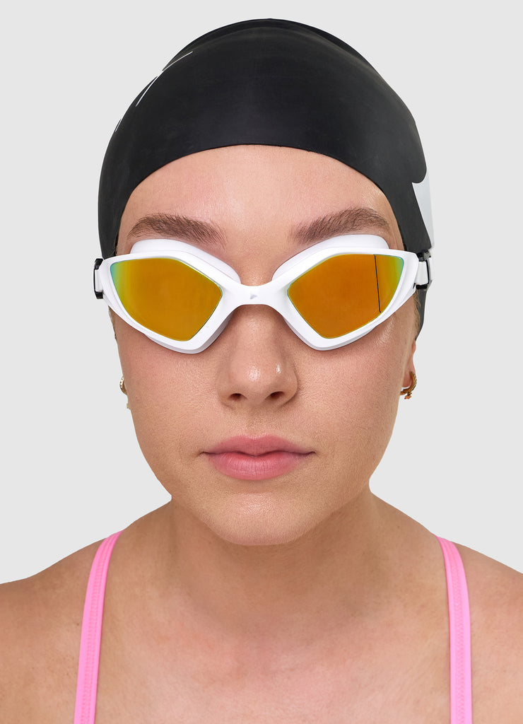 Female swimmer wearing TRI-FIT RAPID-X swim goggles in white