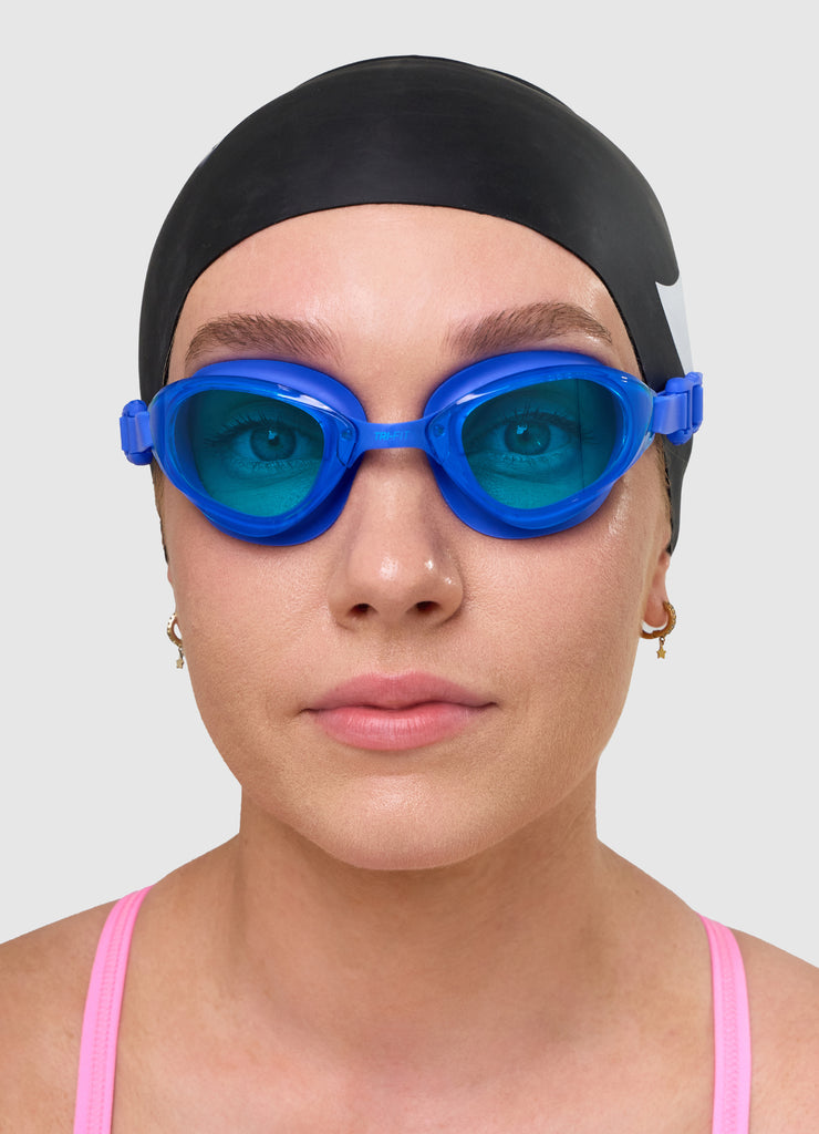 Female wearing TRI-FIT VOLT BLUE swimming goggles.