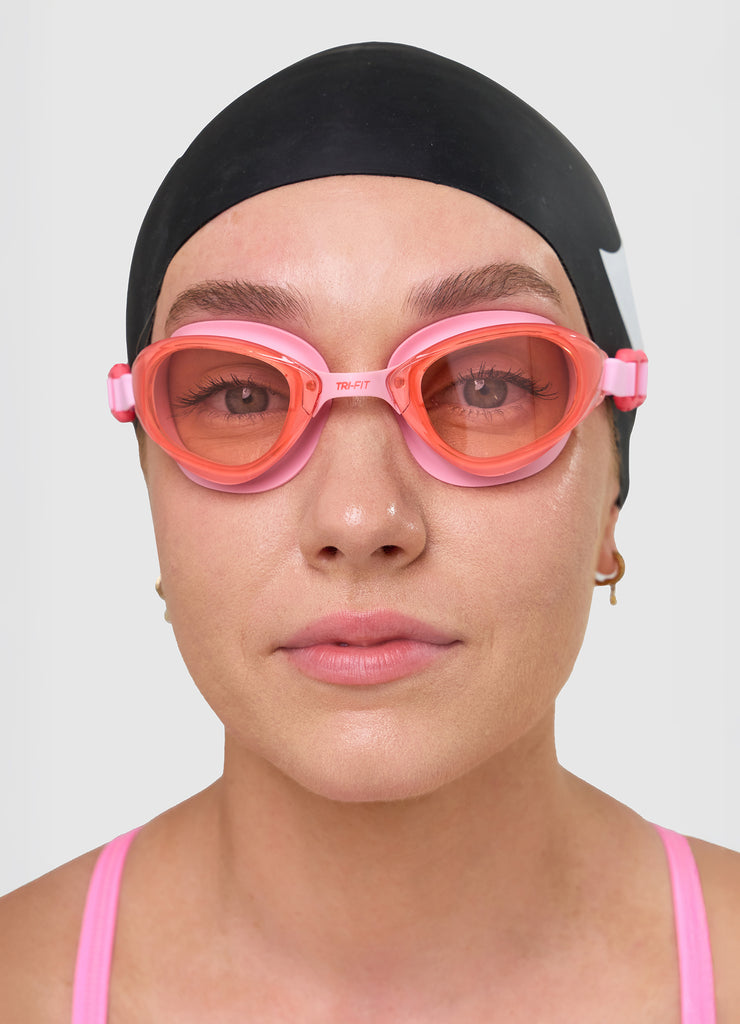 Female wearing TRI-FIT VOLT PINK swimming goggles.