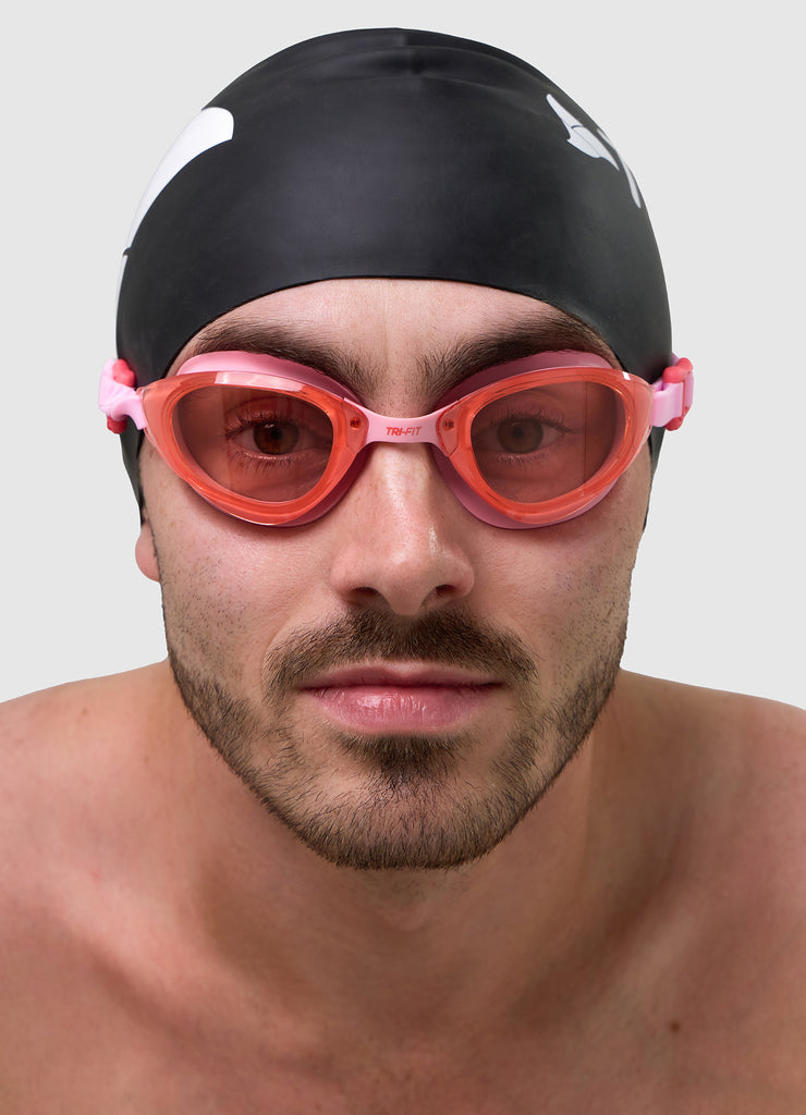 Male wearing TRI-FIT VOLT PINK swimming goggles.