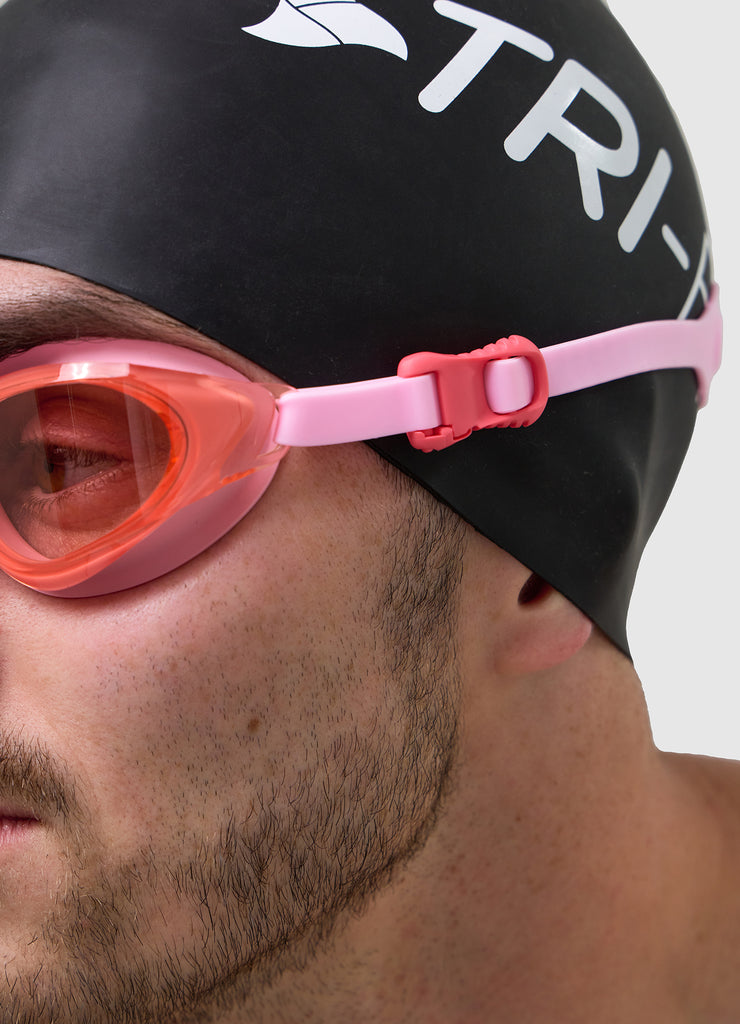 Male wearing TRI-FIT VOLT PINK swimming goggles.