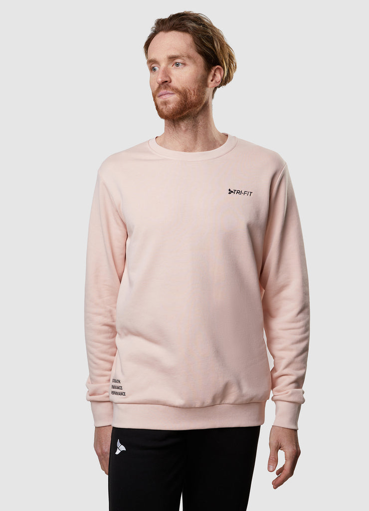 Man wearing TRI-FIT dusty pink crew neck sweater