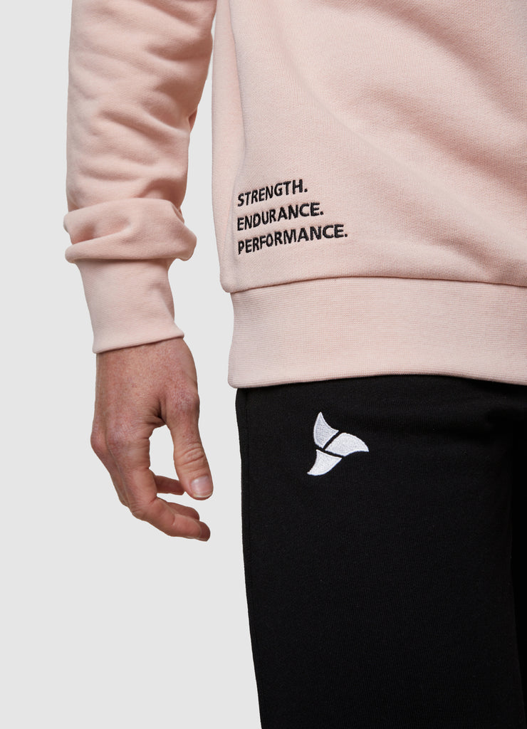 Man wearing TRI-FIT dusty pink crew neck sweater