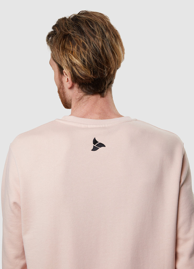 Man wearing TRI-FIT dusty pink crew neck sweater