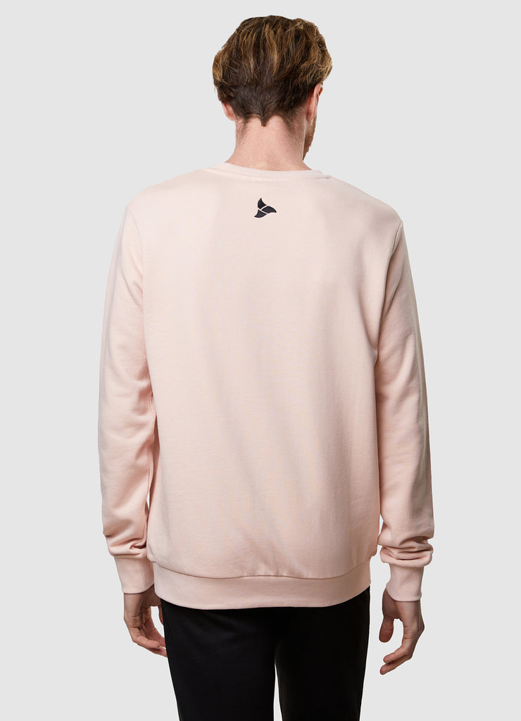 Man wearing TRI-FIT dusty pink crew neck sweater